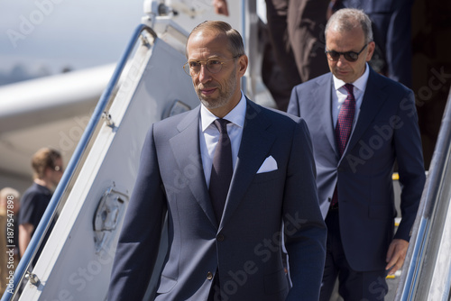 Businessmen Disembarking Airplane