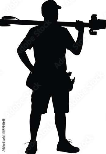 Silhouette of a man with a tool belt holding a camera rig and tripod on his shoulders person carrying
