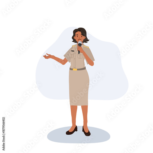 Female government officer speaking into a microphone during a formal presentation.