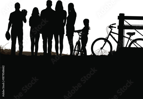 Silhouette of a family with bicycles and a fence in a field at dusk with a baseball glove people children