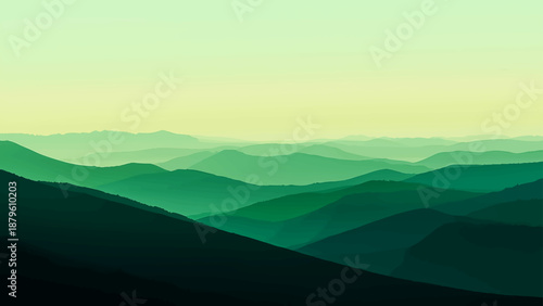 Mist obscured the blue horizon as morning sun rays pierced through clouds and fog over a beautiful mountain landscape at dawn