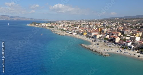 Wallpaper Mural Aerial view of Gallico Beach, Calabria, Italy. It is a Mediterranean coastal town. In foreground there is a sandy beach , with turquoise sea water and residential buildings along the shore. Torontodigital.ca