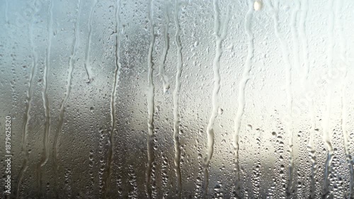 Rain, drops on the glass. Water is flowing.