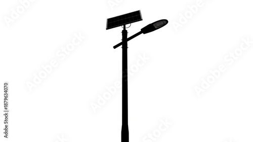 A street light stands tall on a city street at night