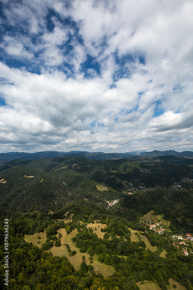 Fototapeta premium View to mountain and forest with cloudy sky