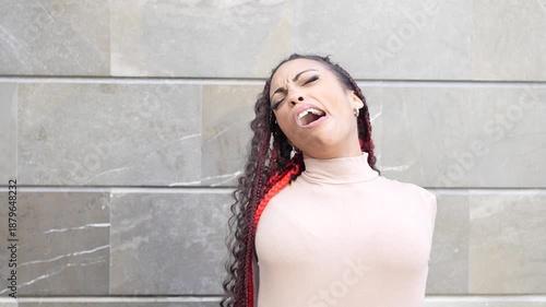 A Striking Portrait of a Confident Woman with Braided Hair Against a Stylish Background