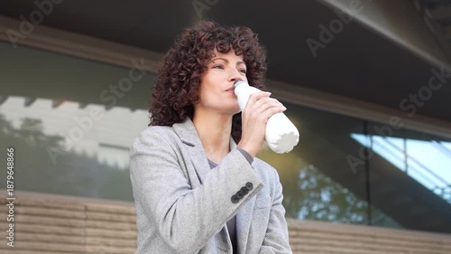 A Young Woman Holding a Milk Bottle While Posing in an Outdoor Setting in Nature