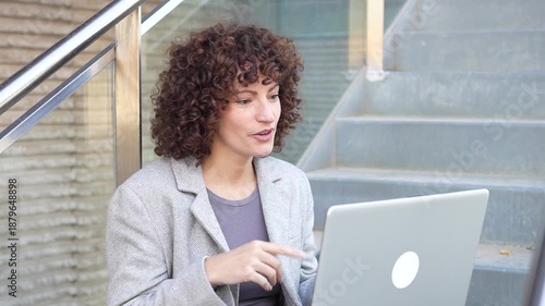 A Young Woman Effectively Engaged in Working on Her Laptop While Happily Enjoying the Great Outdoors
