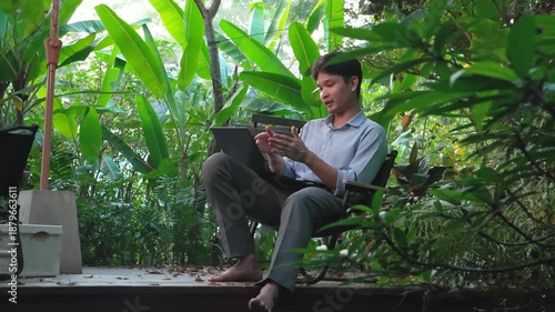 Work from anywhere: A man engaging in an online business discussion via laptop surrounded by nature