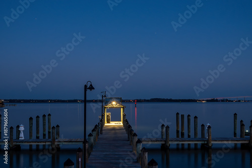 Solomons, Maryland, USA An illuminated pier at night on the Patuxent River.