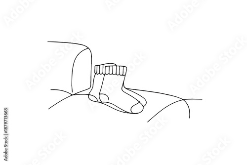Minimalist Winter Socks. Winter wool socks on couch. Minimalistic one-line drawing winter socks placed neatly