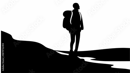 Man standing on hill looking out at landscape with backpack