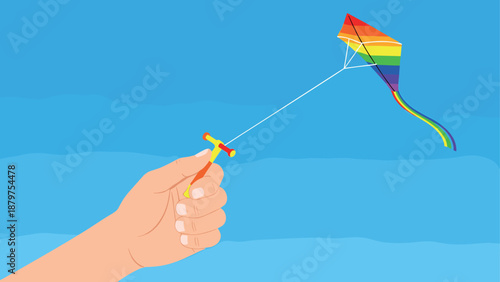 Colorful kite flying in a clear blue sky with hand holding string