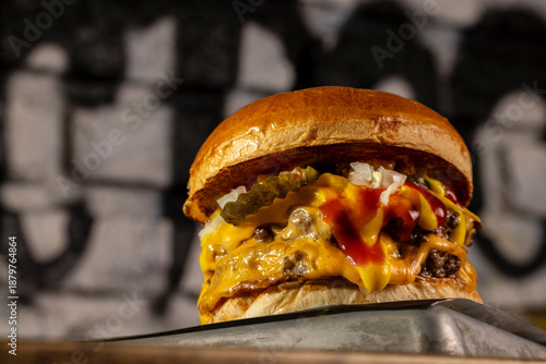 beef burger with onion, pickle, ketchup and mustard