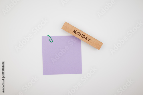 Slika na platnu Wooden block with a word Monday and blank note on a white background