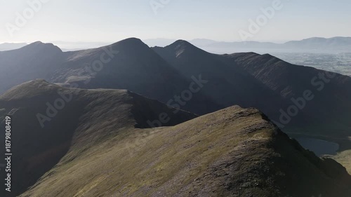 Beautiful landscape on a sunny day. Mountains appear in County Kerry, Ireland, around Carrauntoohil. A peaceful, wide panorama of nature.