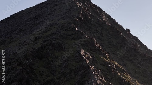 Tranquil mountain top with a cross, symbolizing faith and perseverance.