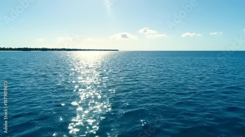Serene Ocean Waves with Sunlight Reflection.