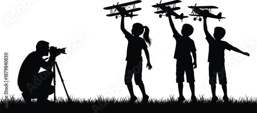 Photographer capturing children playing with toy airplanes outdoors, childhood imagination, aviation dreams, creativity, and playful learning concept