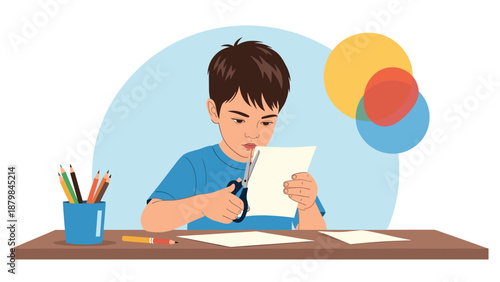 Focused young boy sitting at a desk and carefully cutting a piece of white paper with blue scissors for a school craft project.