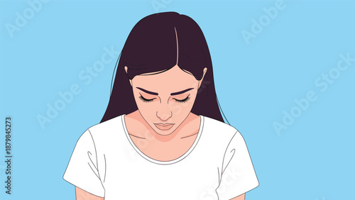 Young woman with dark hair looking down with a somber and pensive expression while standing against a plain blue background.