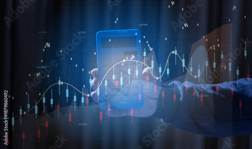 A human hand holds a blue calculator against the background of glowing stock market charts