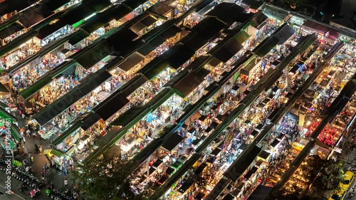 High-angle bird's-eye view timelapse of a vibrant night market in Taiwan, featuring busy stalls and crowds.