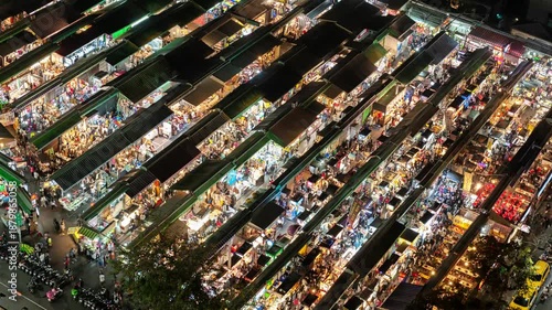 High-angle bird's-eye view timelapse of a vibrant night market in Taiwan, featuring busy stalls and crowds.