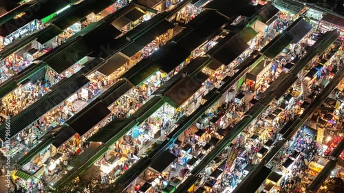 High-angle bird's-eye view timelapse of a vibrant night market in Taiwan, featuring busy stalls and crowds.
