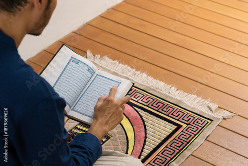 Photos Muslim men is reading koran to worship