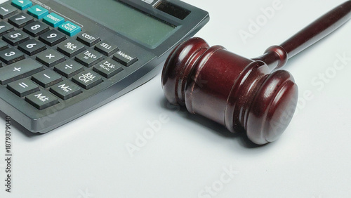 Financial litigation and attorney billing concept with calculator and judge gavel close up