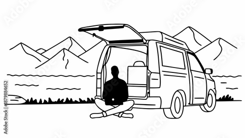 A person meditating outside a van with mountains in the background