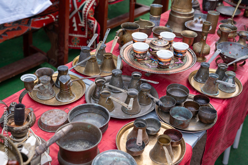 Local market with oriental antiques. Anciant copper vessels.