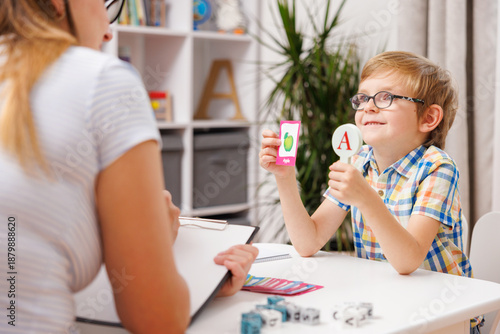 Tableau sur toile Child Learning Alphabet with Teacher Using Flashcards in Classroom