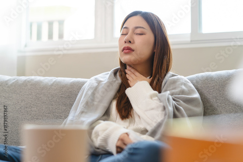 Cuadro en lienzo Sick young woman touching her neck and feeling pain inside the throat effect after coughing too much from influenza in winter season