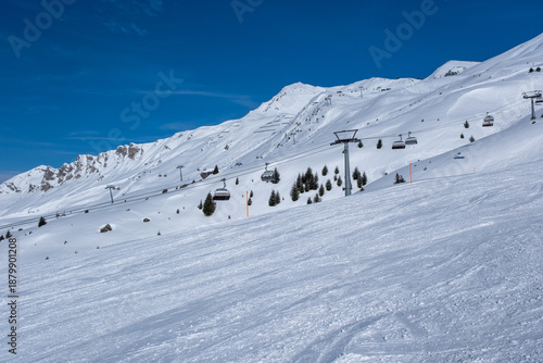 Ski slopes, skiers and beautiful winter landscape in Swiss Alps, Ski region Arosa-Lenzerheide