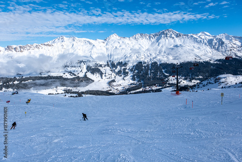 Ski slopes, skiers and beautiful winter landscape in Swiss Alps, Ski region Arosa-Lenzerheide