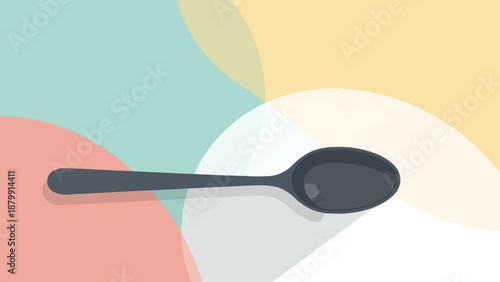 A single dark spoon rests against a background of soft, overlapping pastel shapes