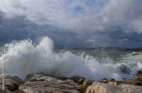 Beautiful seascape.Background of sea waves. Stormy sea waves.Dramatic sea waves crashing against coastal rocks against a cloudy sky.