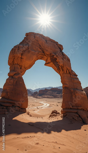 Weathered sandstone arch standing tall under bright desert sun