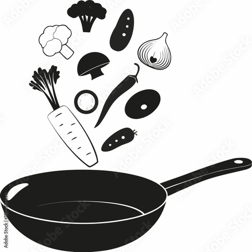 Fresh vegetables are falling into a black frying pan ready for cooking