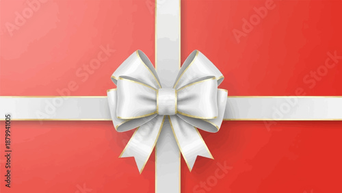 A white bow with gold trim adorns a red gift box