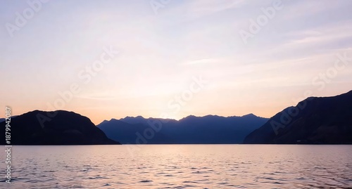 Tranquil Lake at Sunset with Mountain Silhouettes