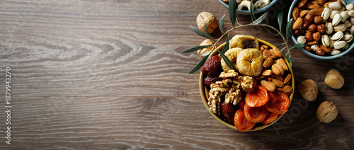 Mixed nuts and dried fruit on a wooden background. Symbols of Jewish holiday Tu Bishvat.