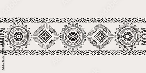 Black and white ornamental band with repeating floral and geometric motifs