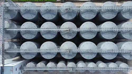 Rows of circular industrial storage tanks at a large manufacturing facility aerial