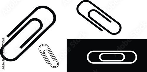 Set of paper clips in various sizes and styles on a white and black background viewed from directly above