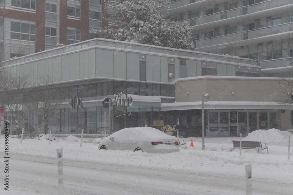 Fototapeta premium exterior building and sign of Vivo Avanti, an Italian restaurant, located at 1832 Bloor St W, during a snow storm on 2026-01-15 in Toronto