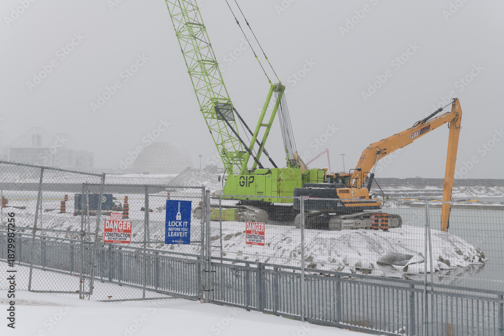 Obraz premium heavy equipment at Ontario Place redevelopment during a snow storm on 2026-01-15 in Toronto