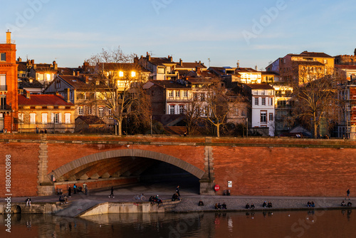 Façades along the Garonne River in the Carmes district illuminated by a winter sunset in Toulouse